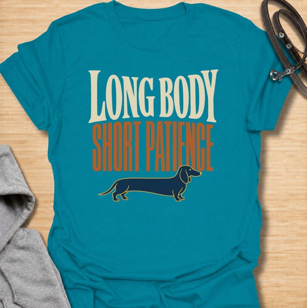 For dachshunds blessed with an impressively long body and a remarkably limited supply of patience. This funny dachshund T-shirt features the phrase “Long Body, Short Patience” with a clean vintage-inspired sausage dog illustration. Perfect for doxie owners who know stubbornness, impatience and plenty of attitude all come with those tiny legs. A bold dog lover tee that captures classic dachshund personality without taking itself too seriously.