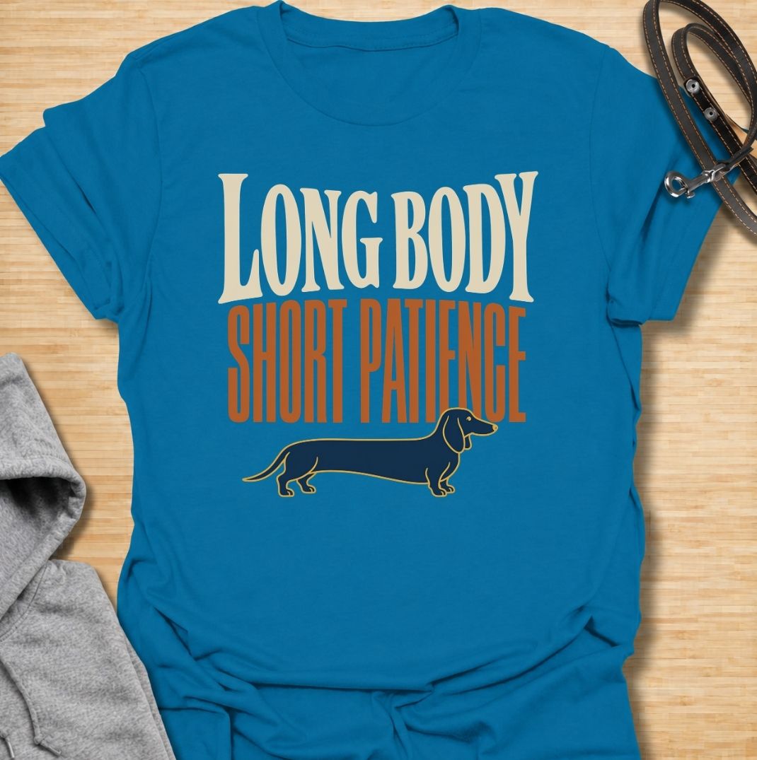 For dachshunds blessed with an impressively long body and a remarkably limited supply of patience. This funny dachshund T-shirt features the phrase “Long Body, Short Patience” with a clean vintage-inspired sausage dog illustration. Perfect for doxie owners who know stubbornness, impatience and plenty of attitude all come with those tiny legs. A bold dog lover tee that captures classic dachshund personality without taking itself too seriously.
