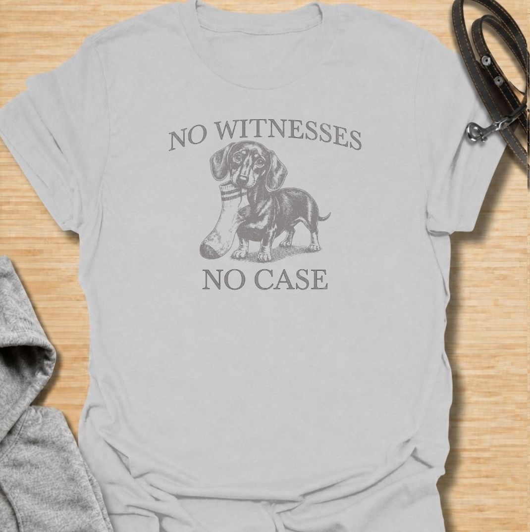 A funny dachshund T-shirt for owners who know their little dog is capable of suspicious behavior. The vintage-style dachshund graphic and “No Witnesses, No Case” phrase give this design a dry, mischievous sense of humor without feeling overly cute. Perfect for dachshund moms, dachshund dads, sausage dog lovers, and anyone familiar with the breed’s stubborn personality. An easy everyday dog lover tee with a retro look that works especially well for fans of funny dachshund shirts and wiener dog humor.