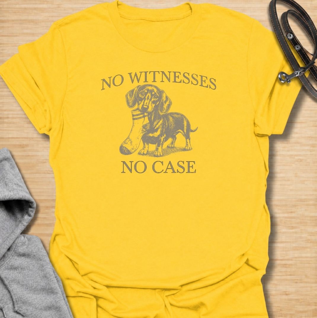 A funny dachshund T-shirt for owners who know their little dog is capable of suspicious behavior. The vintage-style dachshund graphic and “No Witnesses, No Case” phrase give this design a dry, mischievous sense of humor without feeling overly cute. Perfect for dachshund moms, dachshund dads, sausage dog lovers, and anyone familiar with the breed’s stubborn personality. An easy everyday dog lover tee with a retro look that works especially well for fans of funny dachshund shirts and wiener dog humor.