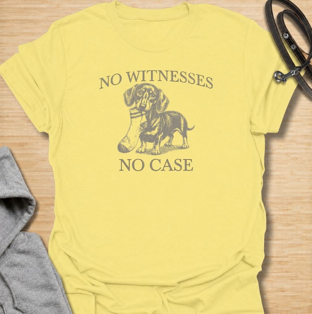 A funny dachshund T-shirt for owners who know their little dog is capable of suspicious behavior. The vintage-style dachshund graphic and “No Witnesses, No Case” phrase give this design a dry, mischievous sense of humor without feeling overly cute. Perfect for dachshund moms, dachshund dads, sausage dog lovers, and anyone familiar with the breed’s stubborn personality. An easy everyday dog lover tee with a retro look that works especially well for fans of funny dachshund shirts and wiener dog humor.