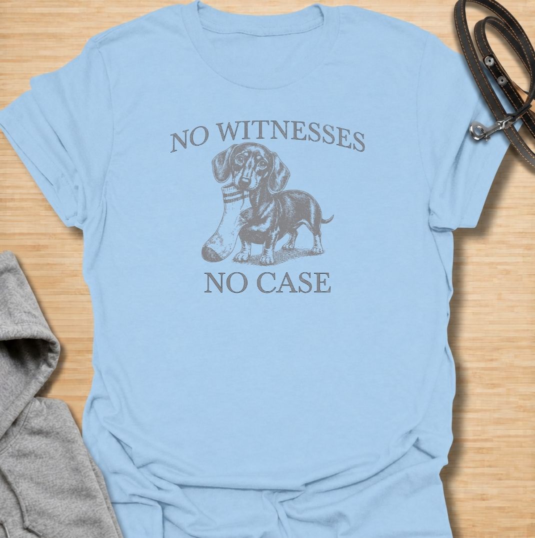 A funny dachshund T-shirt for owners who know their little dog is capable of suspicious behavior. The vintage-style dachshund graphic and “No Witnesses, No Case” phrase give this design a dry, mischievous sense of humor without feeling overly cute. Perfect for dachshund moms, dachshund dads, sausage dog lovers, and anyone familiar with the breed’s stubborn personality. An easy everyday dog lover tee with a retro look that works especially well for fans of funny dachshund shirts and wiener dog humor.