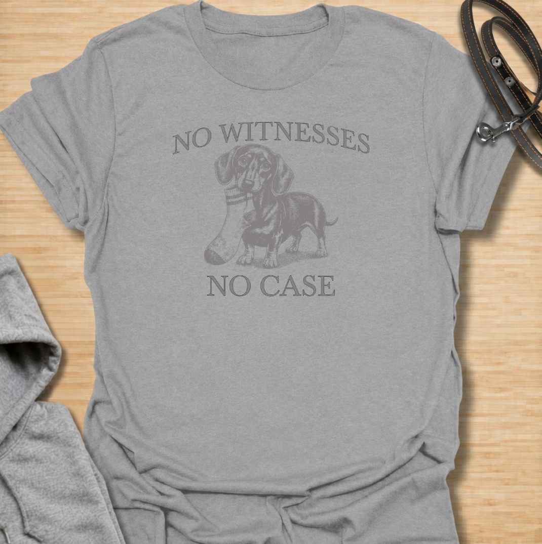 A funny dachshund T-shirt for owners who know their little dog is capable of suspicious behavior. The vintage-style dachshund graphic and “No Witnesses, No Case” phrase give this design a dry, mischievous sense of humor without feeling overly cute. Perfect for dachshund moms, dachshund dads, sausage dog lovers, and anyone familiar with the breed’s stubborn personality. An easy everyday dog lover tee with a retro look that works especially well for fans of funny dachshund shirts and wiener dog humor.