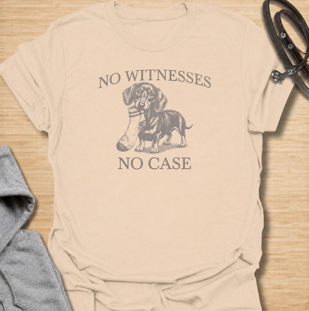 A funny dachshund T-shirt for owners who know their little dog is capable of suspicious behavior. The vintage-style dachshund graphic and “No Witnesses, No Case” phrase give this design a dry, mischievous sense of humor without feeling overly cute. Perfect for dachshund moms, dachshund dads, sausage dog lovers, and anyone familiar with the breed’s stubborn personality. An easy everyday dog lover tee with a retro look that works especially well for fans of funny dachshund shirts and wiener dog humor.