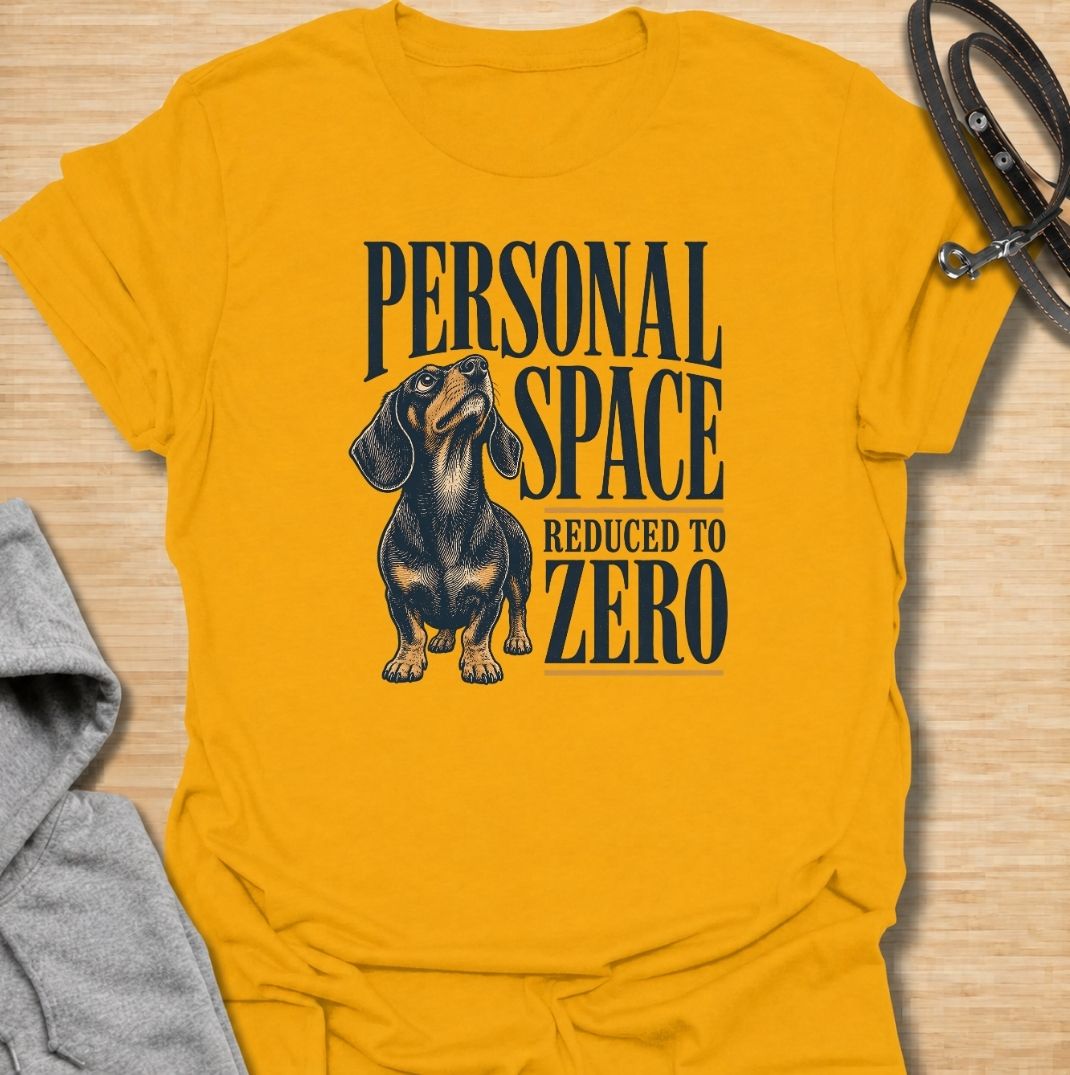 A funny dachshund T-shirt for anyone whose idea of personal space disappeared the moment a dachshund moved in. Featuring the phrase “Personal Space Reduced to Zero” with a bold vintage-style dachshund illustration, this design captures the breed’s famously clingy personality. Perfect for dachshund moms, dachshund dads, sausage dog owners, and anyone who lives with a devoted little shadow. A playful everyday tee for fans of dachshund humor, velcro dogs, and affectionate four-legged companions.