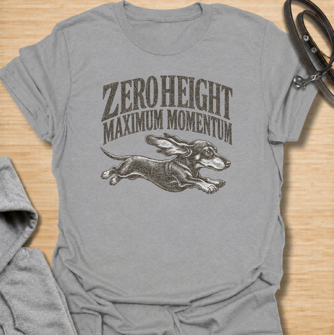 A funny dachshund T-shirt celebrating the surprisingly impressive speed packed into such a low little dog. Featuring the phrase “Zero Height Maximum Momentum” with a running dachshund illustration, this design captures the breed’s energetic and determined personality. Perfect for dachshund moms, dachshund dads, sausage dog owners, and anyone who has seen a dachshund suddenly launch into full-speed mode. A playful vintage-style tee for fans of dachshund humor, wiener dogs, and small dogs with very big energy