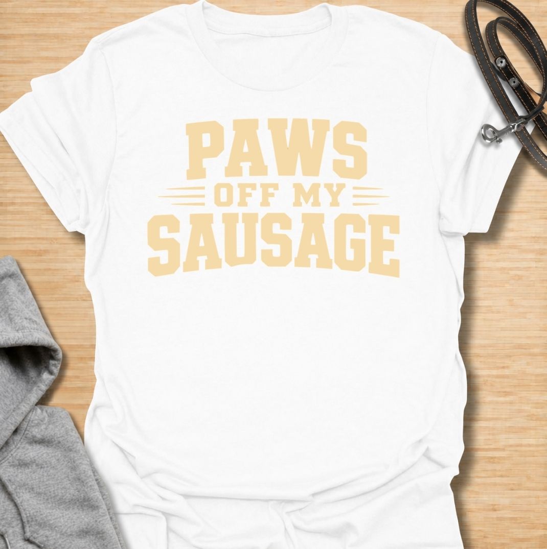 A funny dachshund T-shirt for anyone who takes sausage dog ownership very seriously. Featuring the phrase “Paws Off My Sausage” in bold vintage-inspired lettering, this design delivers a playful double meaning that dachshund lovers will instantly understand. Perfect for dachshund moms, dachshund dads, wiener dog owners, and anyone protective of their favorite little sausage dog. A simple, punchy everyday tee with plenty of dachshund humor and personality.