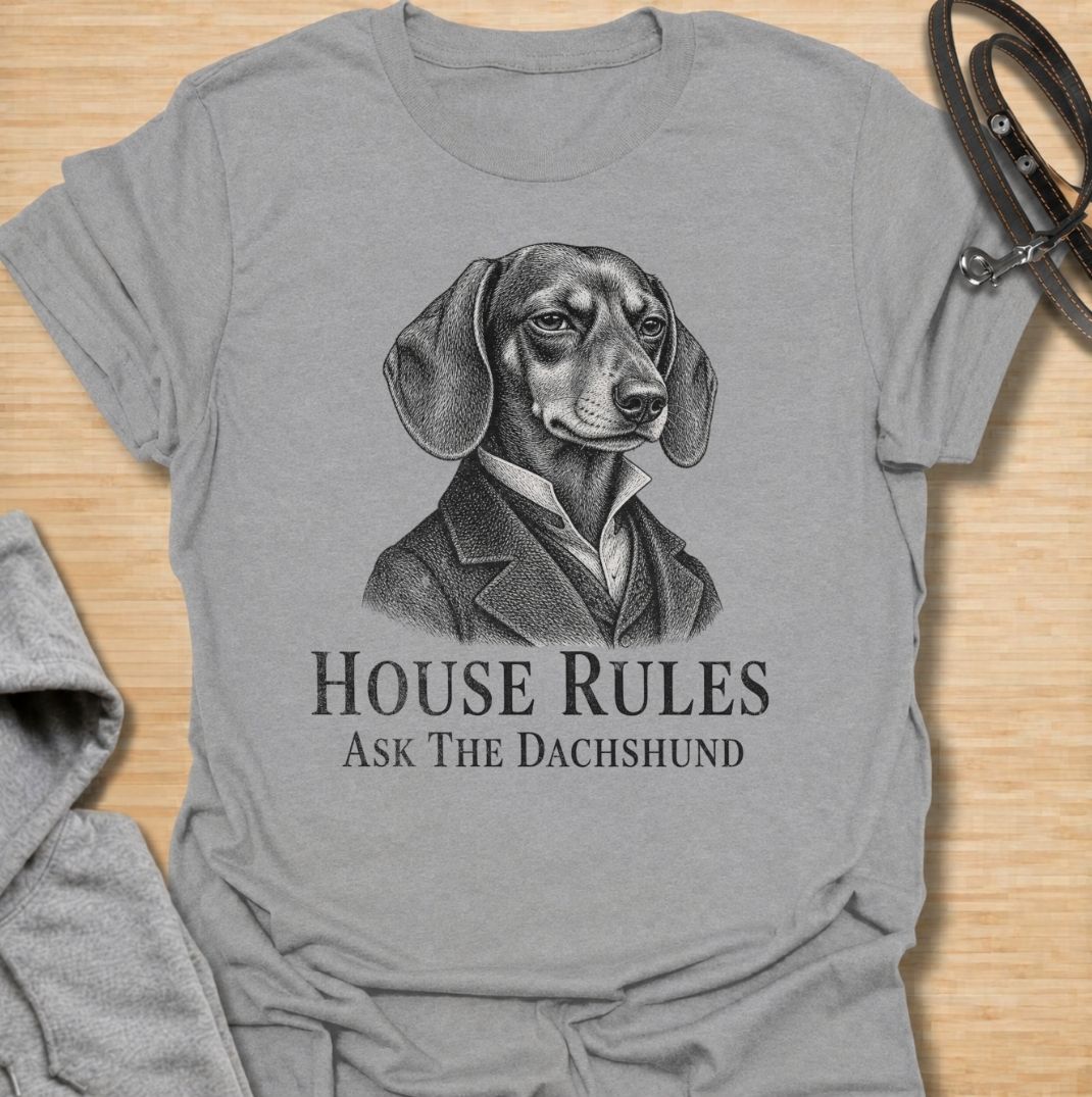A funny dachshund T-shirt for anyone who knows exactly who really makes the rules at home. Featuring a distinguished vintage-style dachshund portrait with the phrase “House Rules — Ask The Dachshund,” this design gives classic artwork a playful dog-owner twist. Perfect for dachshund moms, dachshund dads, sausage dog lovers, and anyone living under the authority of a very opinionated little dog. A quirky everyday tee for fans of dachshund humor, vintage dog art, and breed-specific gifts.