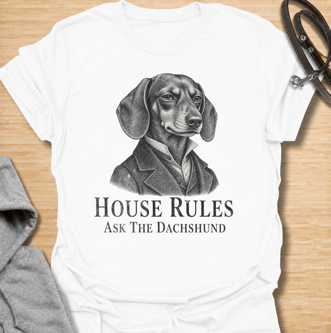 A funny dachshund T-shirt for anyone who knows exactly who really makes the rules at home. Featuring a distinguished vintage-style dachshund portrait with the phrase “House Rules — Ask The Dachshund,” this design gives classic artwork a playful dog-owner twist. Perfect for dachshund moms, dachshund dads, sausage dog lovers, and anyone living under the authority of a very opinionated little dog. A quirky everyday tee for fans of dachshund humor, vintage dog art, and breed-specific gifts.
