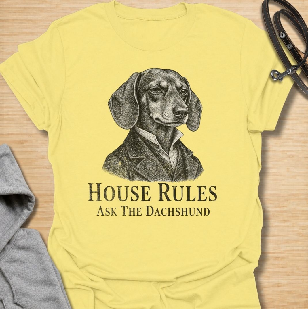 A funny dachshund T-shirt for anyone who knows exactly who really makes the rules at home. Featuring a distinguished vintage-style dachshund portrait with the phrase “House Rules — Ask The Dachshund,” this design gives classic artwork a playful dog-owner twist. Perfect for dachshund moms, dachshund dads, sausage dog lovers, and anyone living under the authority of a very opinionated little dog. A quirky everyday tee for fans of dachshund humor, vintage dog art, and breed-specific gifts.