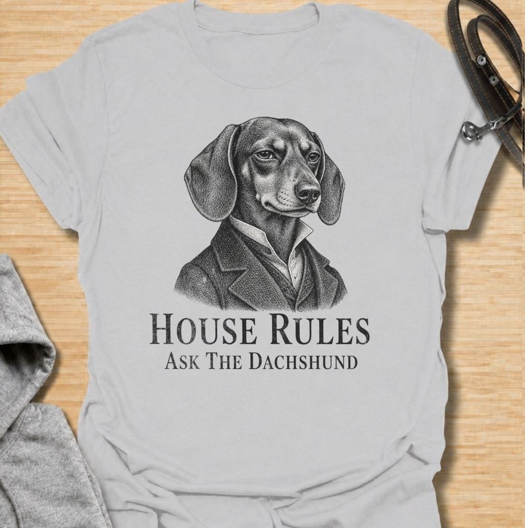 A funny dachshund T-shirt for anyone who knows exactly who really makes the rules at home. Featuring a distinguished vintage-style dachshund portrait with the phrase “House Rules — Ask The Dachshund,” this design gives classic artwork a playful dog-owner twist. Perfect for dachshund moms, dachshund dads, sausage dog lovers, and anyone living under the authority of a very opinionated little dog. A quirky everyday tee for fans of dachshund humor, vintage dog art, and breed-specific gifts.