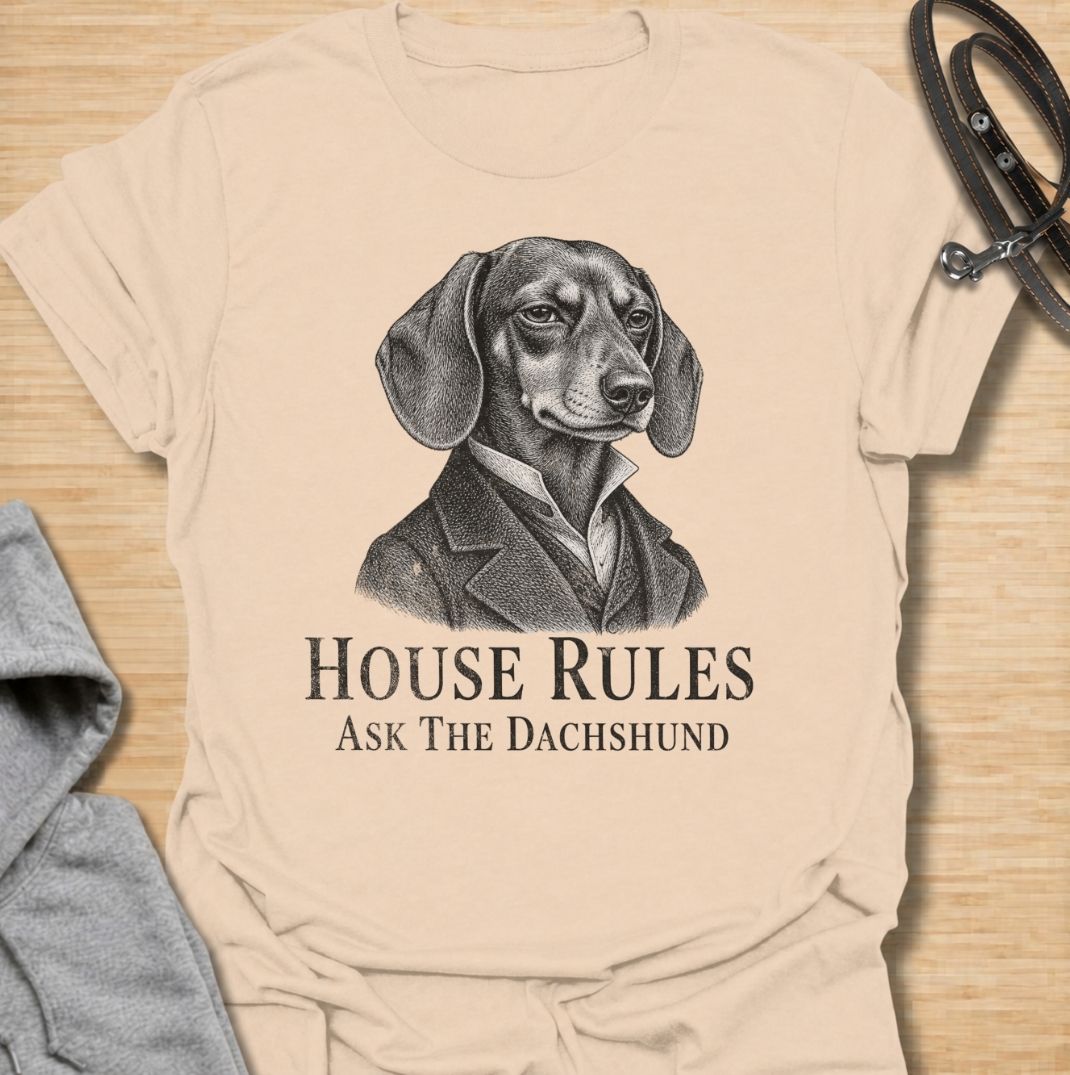 A funny dachshund T-shirt for anyone who knows exactly who really makes the rules at home. Featuring a distinguished vintage-style dachshund portrait with the phrase “House Rules — Ask The Dachshund,” this design gives classic artwork a playful dog-owner twist. Perfect for dachshund moms, dachshund dads, sausage dog lovers, and anyone living under the authority of a very opinionated little dog. A quirky everyday tee for fans of dachshund humor, vintage dog art, and breed-specific gifts.