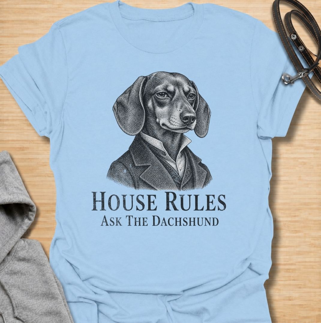 A funny dachshund T-shirt for anyone who knows exactly who really makes the rules at home. Featuring a distinguished vintage-style dachshund portrait with the phrase “House Rules — Ask The Dachshund,” this design gives classic artwork a playful dog-owner twist. Perfect for dachshund moms, dachshund dads, sausage dog lovers, and anyone living under the authority of a very opinionated little dog. A quirky everyday tee for fans of dachshund humor, vintage dog art, and breed-specific gifts.