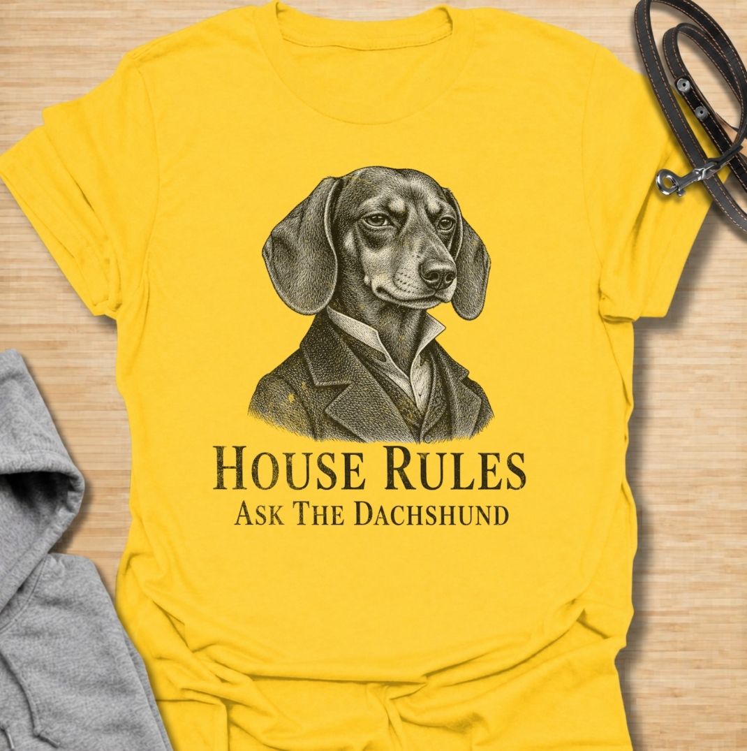 A funny dachshund T-shirt for anyone who knows exactly who really makes the rules at home. Featuring a distinguished vintage-style dachshund portrait with the phrase “House Rules — Ask The Dachshund,” this design gives classic artwork a playful dog-owner twist. Perfect for dachshund moms, dachshund dads, sausage dog lovers, and anyone living under the authority of a very opinionated little dog. A quirky everyday tee for fans of dachshund humor, vintage dog art, and breed-specific gifts.