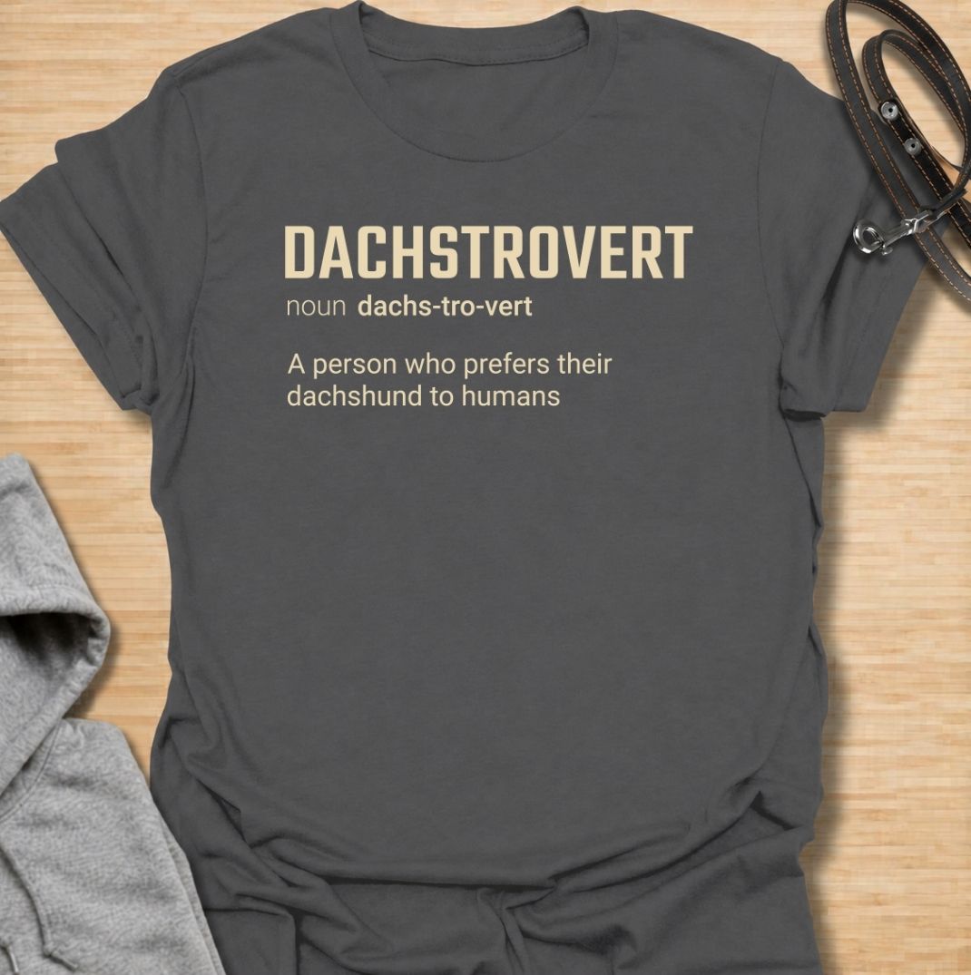 A funny dachshund T-shirt for anyone who would rather spend time with their dog than make small talk with people. Featuring the invented definition “Dachstrovert — A person who prefers their dachshund to humans,” this design has a clean dictionary-style layout with dry, relatable humor. Perfect for dachshund moms, dachshund dads, introverts, sausage dog lovers, and anyone whose favorite company has four short legs. A simple everyday tee for fans of dachshund humor, funny dog sayings, and breed-specific gift