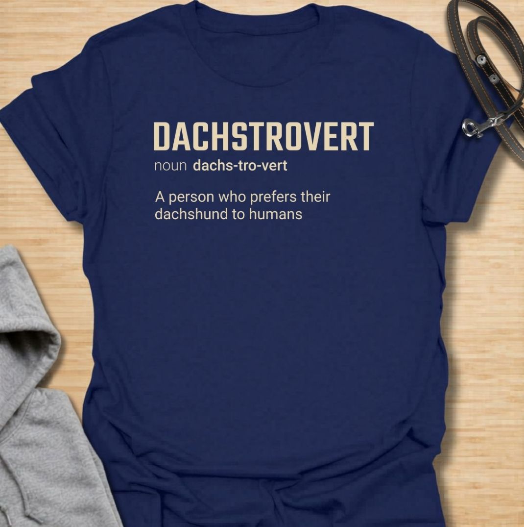 A funny dachshund T-shirt for anyone who would rather spend time with their dog than make small talk with people. Featuring the invented definition “Dachstrovert — A person who prefers their dachshund to humans,” this design has a clean dictionary-style layout with dry, relatable humor. Perfect for dachshund moms, dachshund dads, introverts, sausage dog lovers, and anyone whose favorite company has four short legs. A simple everyday tee for fans of dachshund humor, funny dog sayings, and breed-specific gift