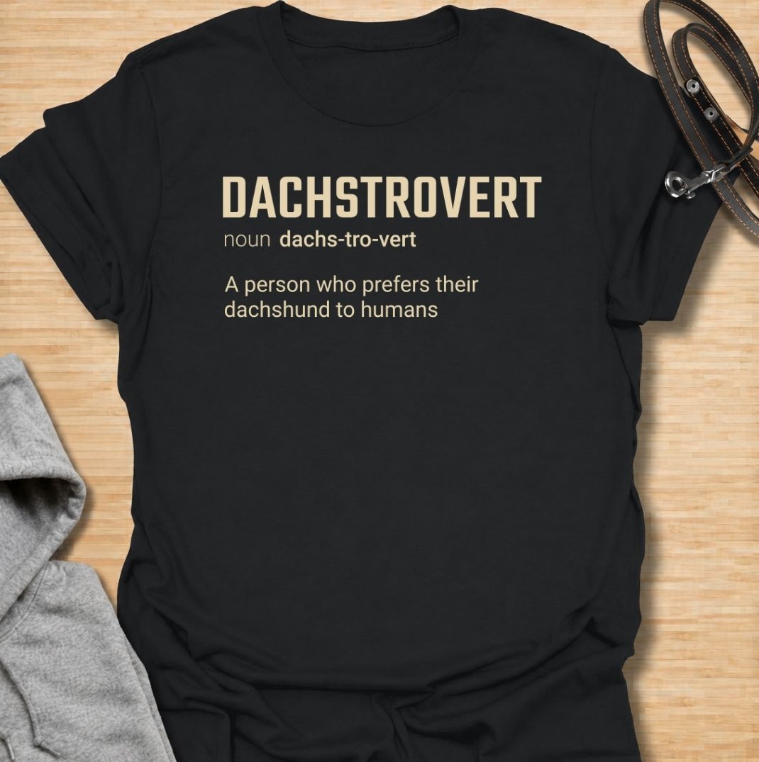 A funny dachshund T-shirt for anyone who would rather spend time with their dog than make small talk with people. Featuring the invented definition “Dachstrovert — A person who prefers their dachshund to humans,” this design has a clean dictionary-style layout with dry, relatable humor. Perfect for dachshund moms, dachshund dads, introverts, sausage dog lovers, and anyone whose favorite company has four short legs. A simple everyday tee for fans of dachshund humor, funny dog sayings, and breed-specific gift