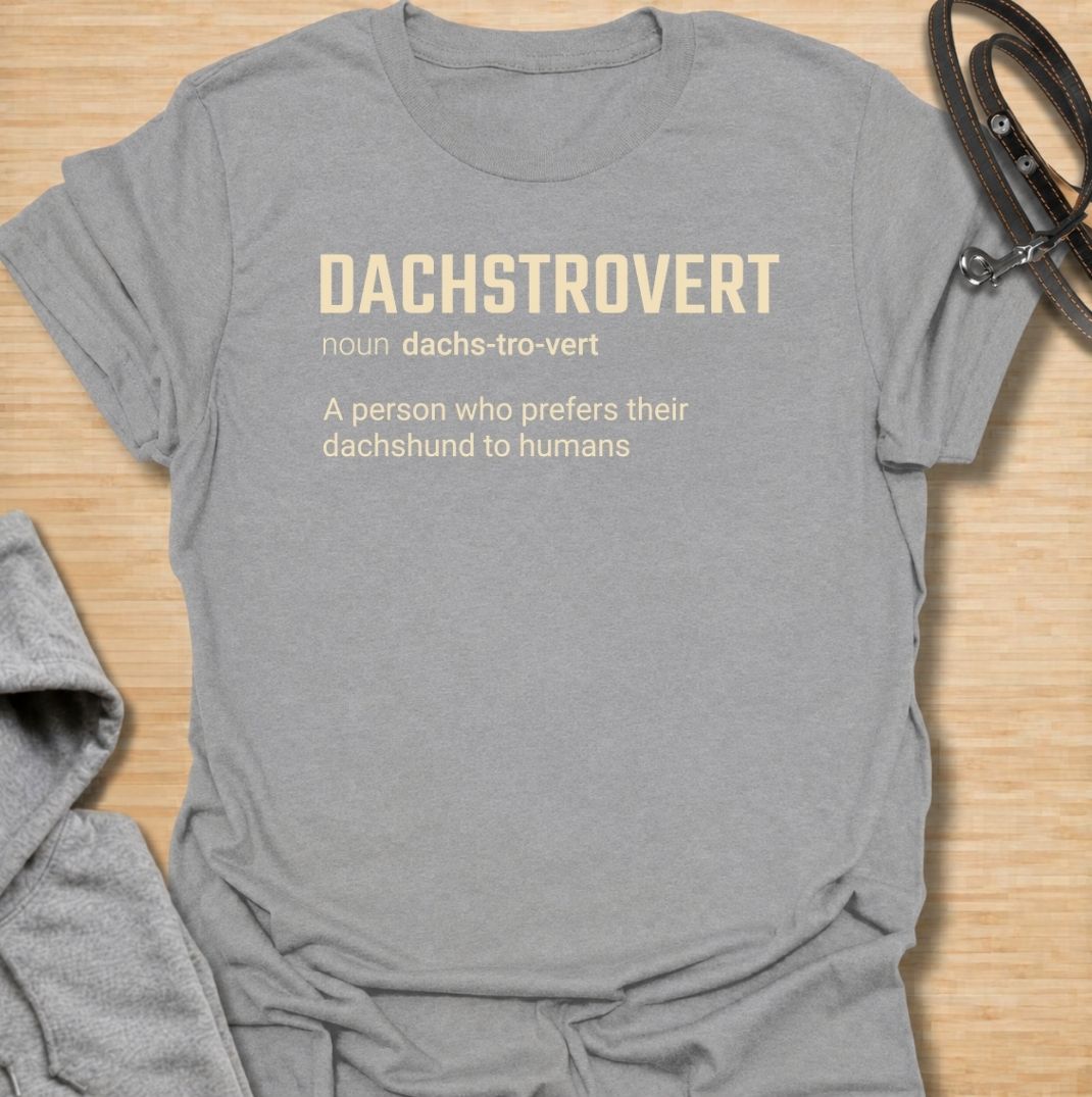 A funny dachshund T-shirt for anyone who would rather spend time with their dog than make small talk with people. Featuring the invented definition “Dachstrovert — A person who prefers their dachshund to humans,” this design has a clean dictionary-style layout with dry, relatable humor. Perfect for dachshund moms, dachshund dads, introverts, sausage dog lovers, and anyone whose favorite company has four short legs. A simple everyday tee for fans of dachshund humor, funny dog sayings, and breed-specific gift