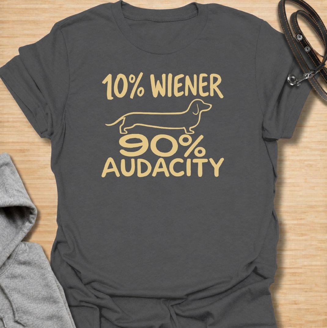 A funny dachshund T-shirt for anyone who knows that being small has absolutely no effect on a dachshund’s confidence. Featuring the phrase “10% Wiener, 90% Audacity” with a simple sausage dog outline, this design captures the breed’s bold, stubborn, larger-than-life personality. Perfect for dachshund moms, dachshund dads, wiener dog owners, and anyone familiar with the attitude packed into those short little legs. A playful everyday tee for fans of dachshund humor, sausage dog jokes, and breed-specific gift