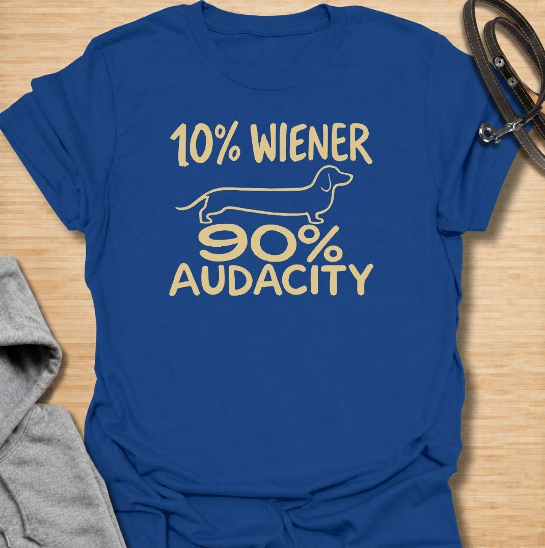 A funny dachshund T-shirt for anyone who knows that being small has absolutely no effect on a dachshund’s confidence. Featuring the phrase “10% Wiener, 90% Audacity” with a simple sausage dog outline, this design captures the breed’s bold, stubborn, larger-than-life personality. Perfect for dachshund moms, dachshund dads, wiener dog owners, and anyone familiar with the attitude packed into those short little legs. A playful everyday tee for fans of dachshund humor, sausage dog jokes, and breed-specific gift