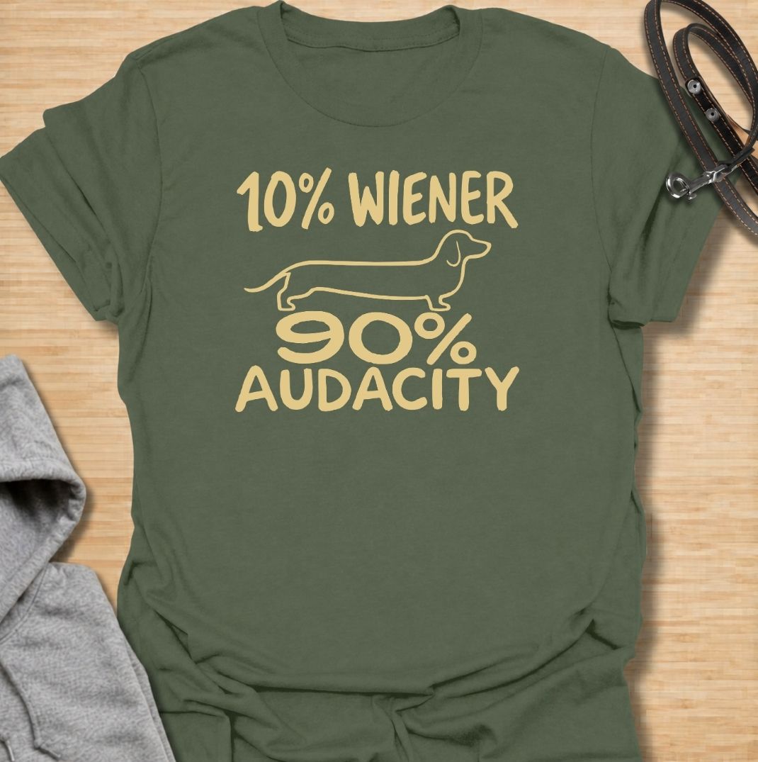 A funny dachshund T-shirt for anyone who knows that being small has absolutely no effect on a dachshund’s confidence. Featuring the phrase “10% Wiener, 90% Audacity” with a simple sausage dog outline, this design captures the breed’s bold, stubborn, larger-than-life personality. Perfect for dachshund moms, dachshund dads, wiener dog owners, and anyone familiar with the attitude packed into those short little legs. A playful everyday tee for fans of dachshund humor, sausage dog jokes, and breed-specific gift