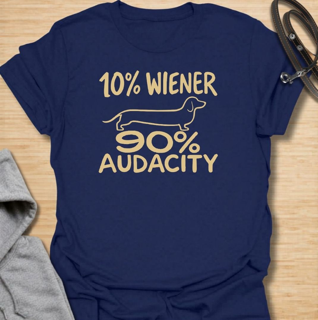 A funny dachshund T-shirt for anyone who knows that being small has absolutely no effect on a dachshund’s confidence. Featuring the phrase “10% Wiener, 90% Audacity” with a simple sausage dog outline, this design captures the breed’s bold, stubborn, larger-than-life personality. Perfect for dachshund moms, dachshund dads, wiener dog owners, and anyone familiar with the attitude packed into those short little legs. A playful everyday tee for fans of dachshund humor, sausage dog jokes, and breed-specific gift