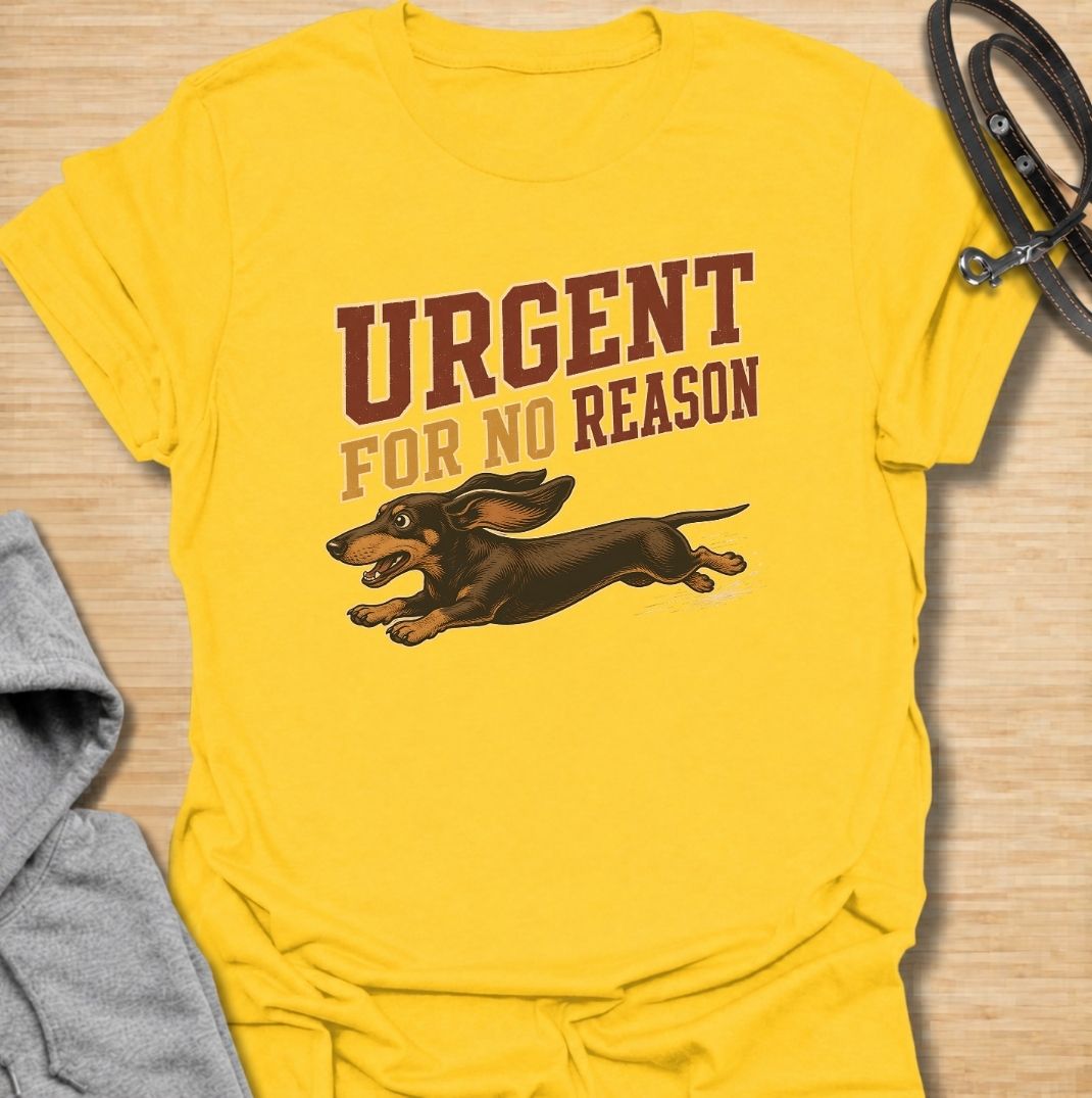 A funny dachshund T-shirt for anyone familiar with the sudden bursts of speed that seem to come from absolutely nowhere. Featuring the phrase “Urgent For No Reason” with a running dachshund illustration, this design captures the breed’s energetic, dramatic personality perfectly. Ideal for dachshund moms, dachshund dads, sausage dog owners, and anyone who has witnessed an unexpected dachshund sprint across the house or yard. A playful everyday tee for fans of dachshund humor, wiener dog chaos, and small dogs