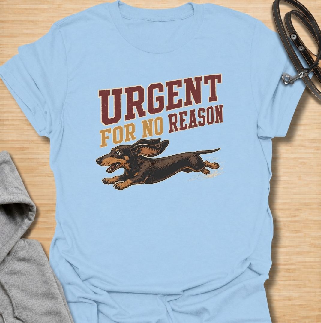 A funny dachshund T-shirt for anyone familiar with the sudden bursts of speed that seem to come from absolutely nowhere. Featuring the phrase “Urgent For No Reason” with a running dachshund illustration, this design captures the breed’s energetic, dramatic personality perfectly. Ideal for dachshund moms, dachshund dads, sausage dog owners, and anyone who has witnessed an unexpected dachshund sprint across the house or yard. A playful everyday tee for fans of dachshund humor, wiener dog chaos, and small dogs