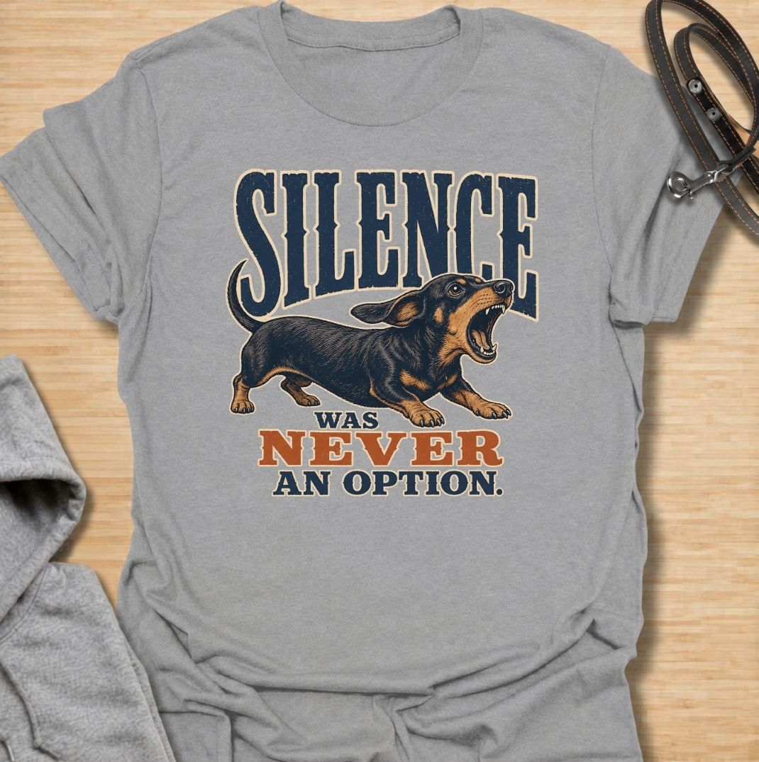 A funny dachshund T-shirt for anyone who knows silence is rarely part of life with a sausage dog. Featuring the phrase “Silence Was Never an Option” with a barking dachshund illustration, this design captures the breed’s loud, opinionated personality perfectly. Ideal for dachshund moms, dachshund dads, wiener dog owners, and anyone whose little dog always has something to say. A bold everyday tee for fans of dachshund humor, noisy dogs, and small dogs with very big voices.