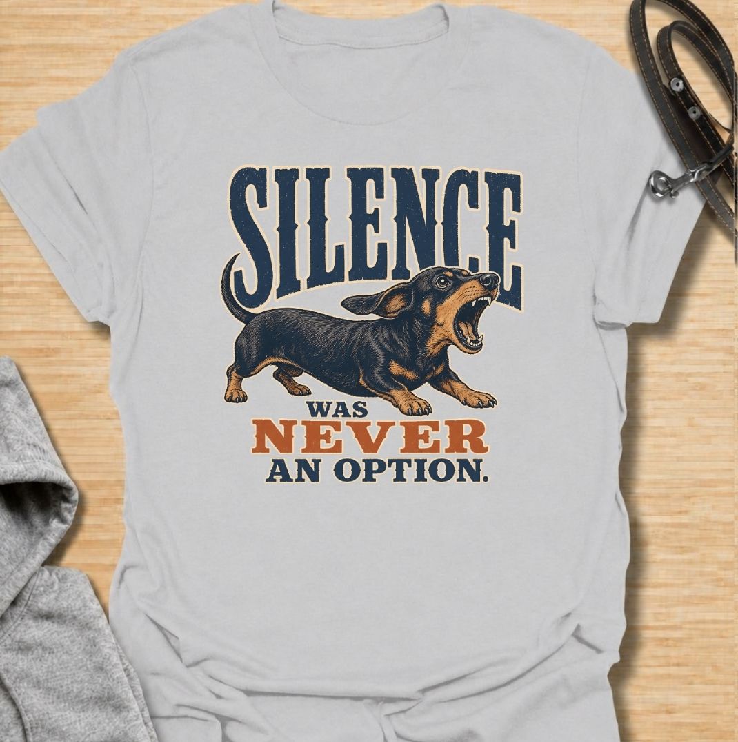 A funny dachshund T-shirt for anyone who knows silence is rarely part of life with a sausage dog. Featuring the phrase “Silence Was Never an Option” with a barking dachshund illustration, this design captures the breed’s loud, opinionated personality perfectly. Ideal for dachshund moms, dachshund dads, wiener dog owners, and anyone whose little dog always has something to say. A bold everyday tee for fans of dachshund humor, noisy dogs, and small dogs with very big voices.
