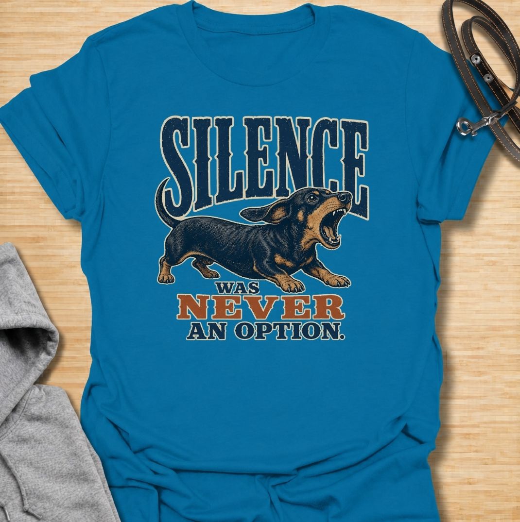 A funny dachshund T-shirt for anyone who knows silence is rarely part of life with a sausage dog. Featuring the phrase “Silence Was Never an Option” with a barking dachshund illustration, this design captures the breed’s loud, opinionated personality perfectly. Ideal for dachshund moms, dachshund dads, wiener dog owners, and anyone whose little dog always has something to say. A bold everyday tee for fans of dachshund humor, noisy dogs, and small dogs with very big voices.