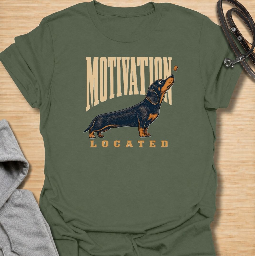 A funny dachshund T-shirt for anyone who knows exactly what gets a sausage dog moving. Featuring the phrase “Motivation Located” with a dachshund focused firmly on a treat, this design captures the breed’s famously food-driven personality. Perfect for dachshund moms, dachshund dads, wiener dog owners, and anyone familiar with just how effective snacks can be. A playful everyday tee for fans of dachshund humor, treat-obsessed dogs, and small dogs with very clear priorities.