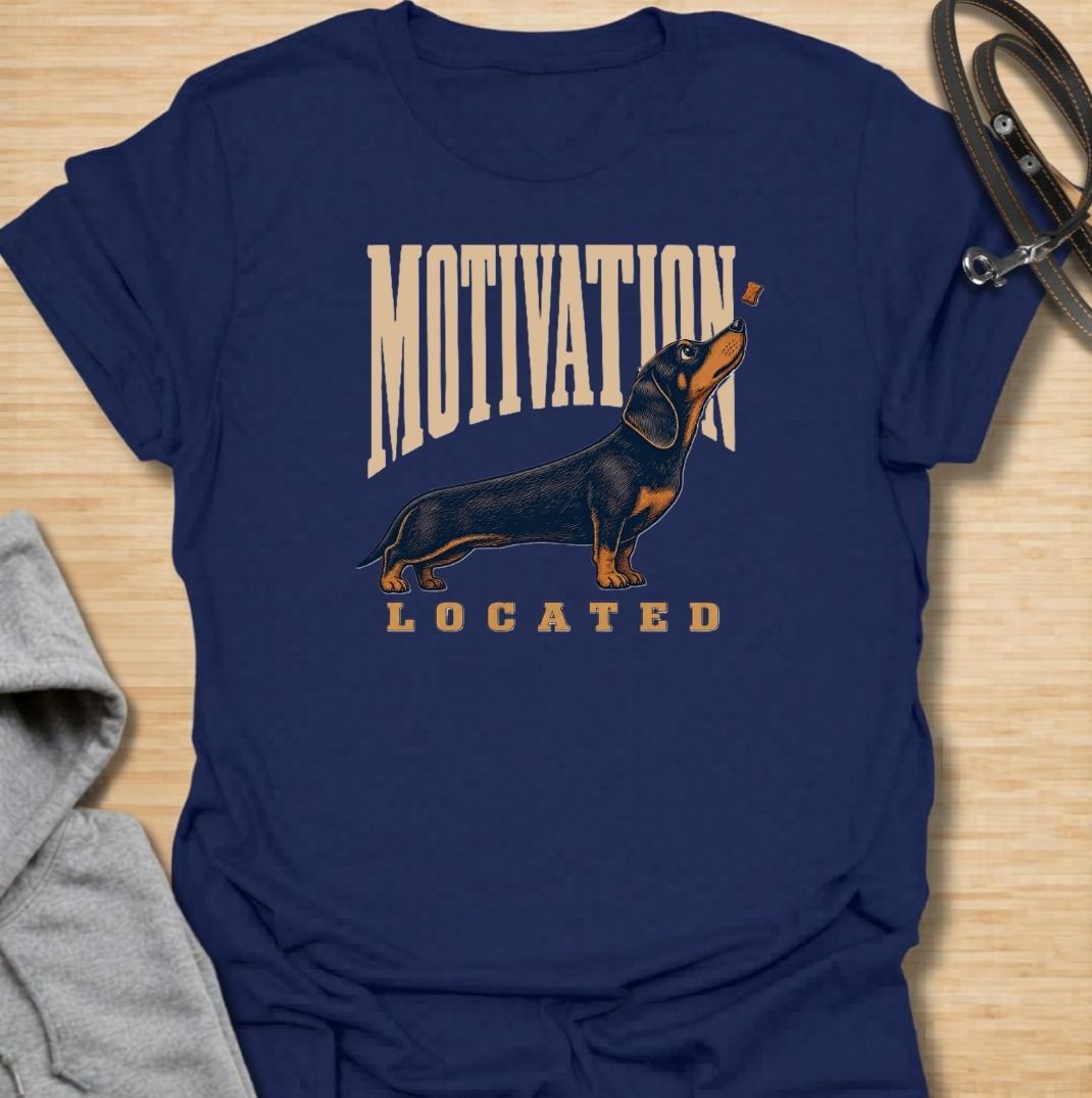 A funny dachshund T-shirt for anyone who knows exactly what gets a sausage dog moving. Featuring the phrase “Motivation Located” with a dachshund focused firmly on a treat, this design captures the breed’s famously food-driven personality. Perfect for dachshund moms, dachshund dads, wiener dog owners, and anyone familiar with just how effective snacks can be. A playful everyday tee for fans of dachshund humor, treat-obsessed dogs, and small dogs with very clear priorities.