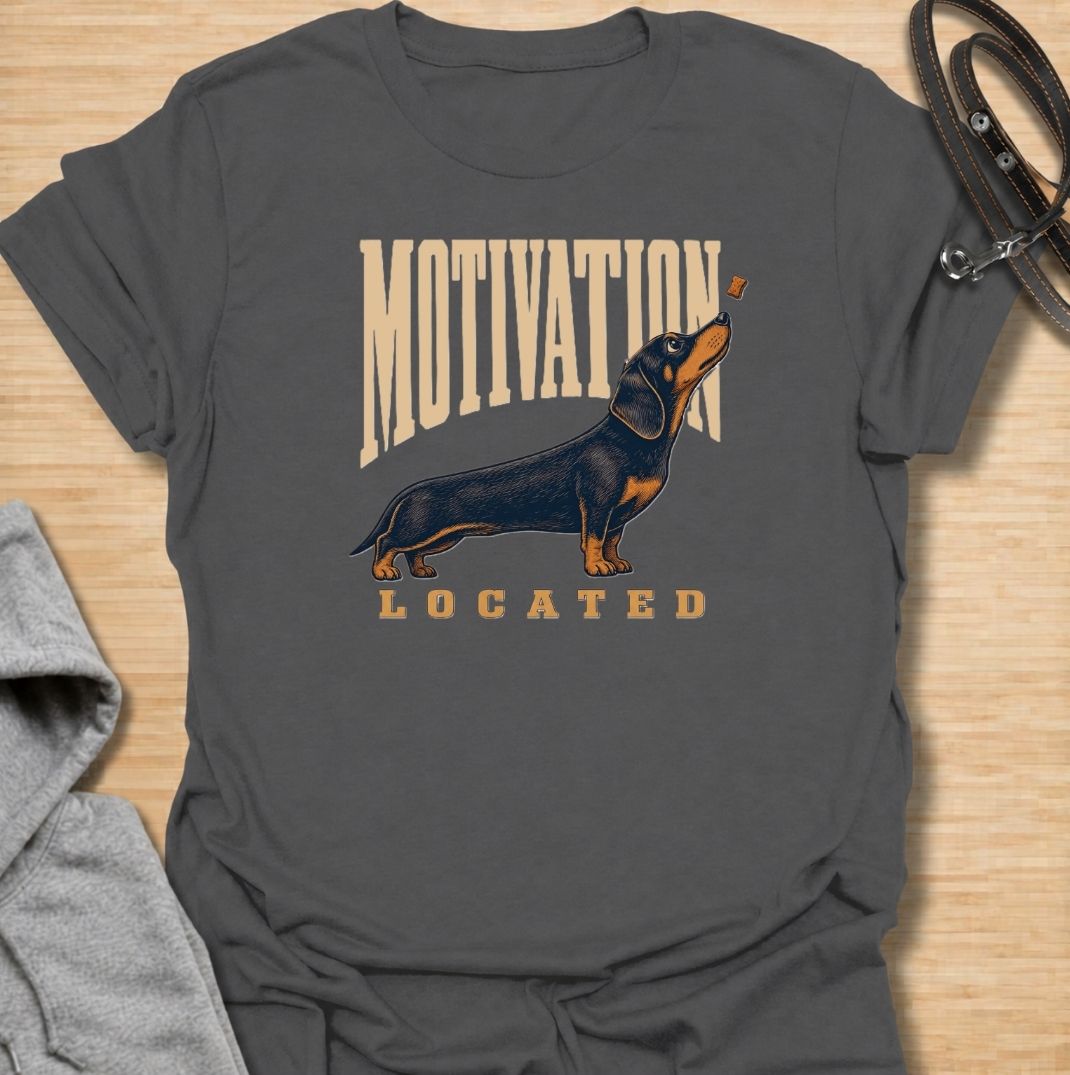 A funny dachshund T-shirt for anyone who knows exactly what gets a sausage dog moving. Featuring the phrase “Motivation Located” with a dachshund focused firmly on a treat, this design captures the breed’s famously food-driven personality. Perfect for dachshund moms, dachshund dads, wiener dog owners, and anyone familiar with just how effective snacks can be. A playful everyday tee for fans of dachshund humor, treat-obsessed dogs, and small dogs with very clear priorities.