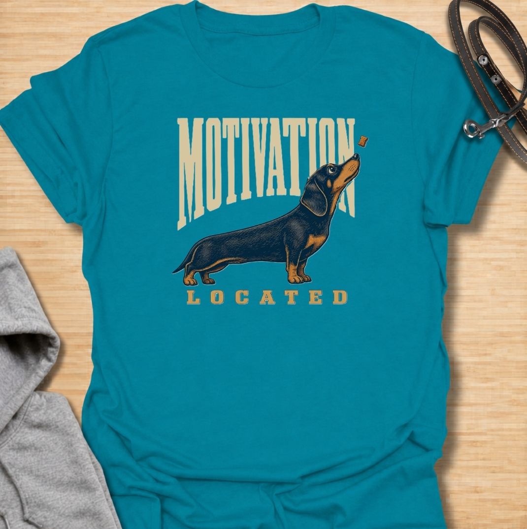 A funny dachshund T-shirt for anyone who knows exactly what gets a sausage dog moving. Featuring the phrase “Motivation Located” with a dachshund focused firmly on a treat, this design captures the breed’s famously food-driven personality. Perfect for dachshund moms, dachshund dads, wiener dog owners, and anyone familiar with just how effective snacks can be. A playful everyday tee for fans of dachshund humor, treat-obsessed dogs, and small dogs with very clear priorities.