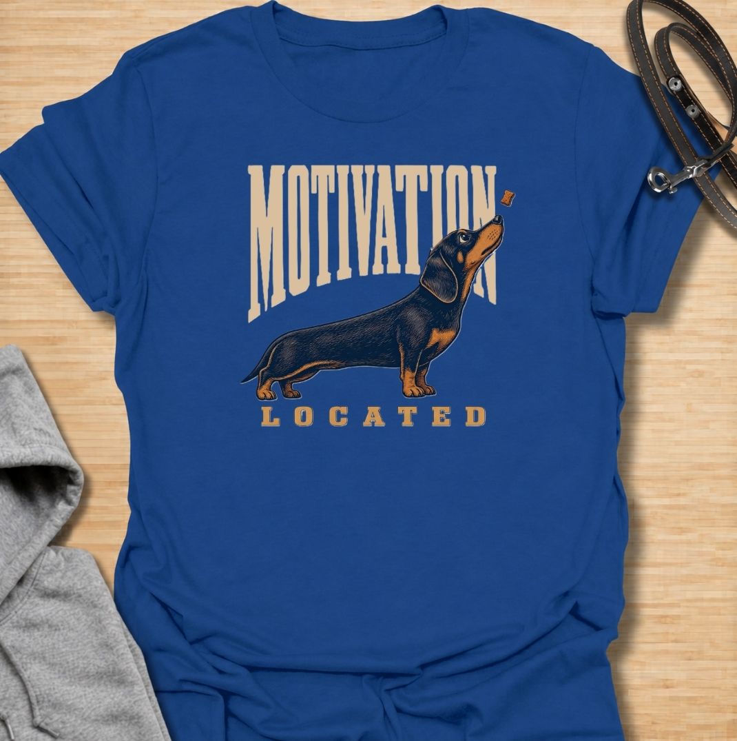 A funny dachshund T-shirt for anyone who knows exactly what gets a sausage dog moving. Featuring the phrase “Motivation Located” with a dachshund focused firmly on a treat, this design captures the breed’s famously food-driven personality. Perfect for dachshund moms, dachshund dads, wiener dog owners, and anyone familiar with just how effective snacks can be. A playful everyday tee for fans of dachshund humor, treat-obsessed dogs, and small dogs with very clear priorities.