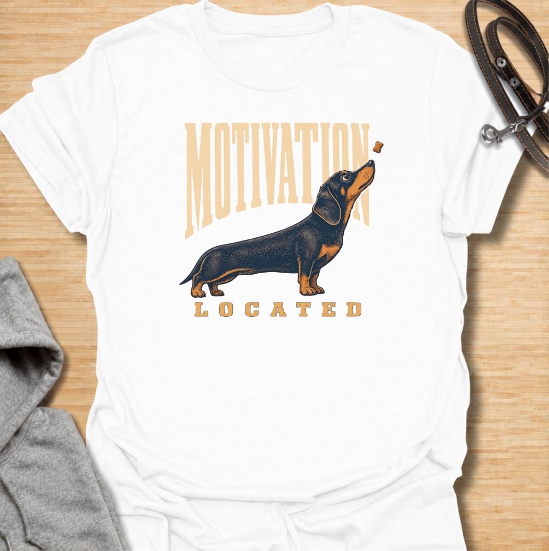 A funny dachshund T-shirt for anyone who knows exactly what gets a sausage dog moving. Featuring the phrase “Motivation Located” with a dachshund focused firmly on a treat, this design captures the breed’s famously food-driven personality. Perfect for dachshund moms, dachshund dads, wiener dog owners, and anyone familiar with just how effective snacks can be. A playful everyday tee for fans of dachshund humor, treat-obsessed dogs, and small dogs with very clear priorities.