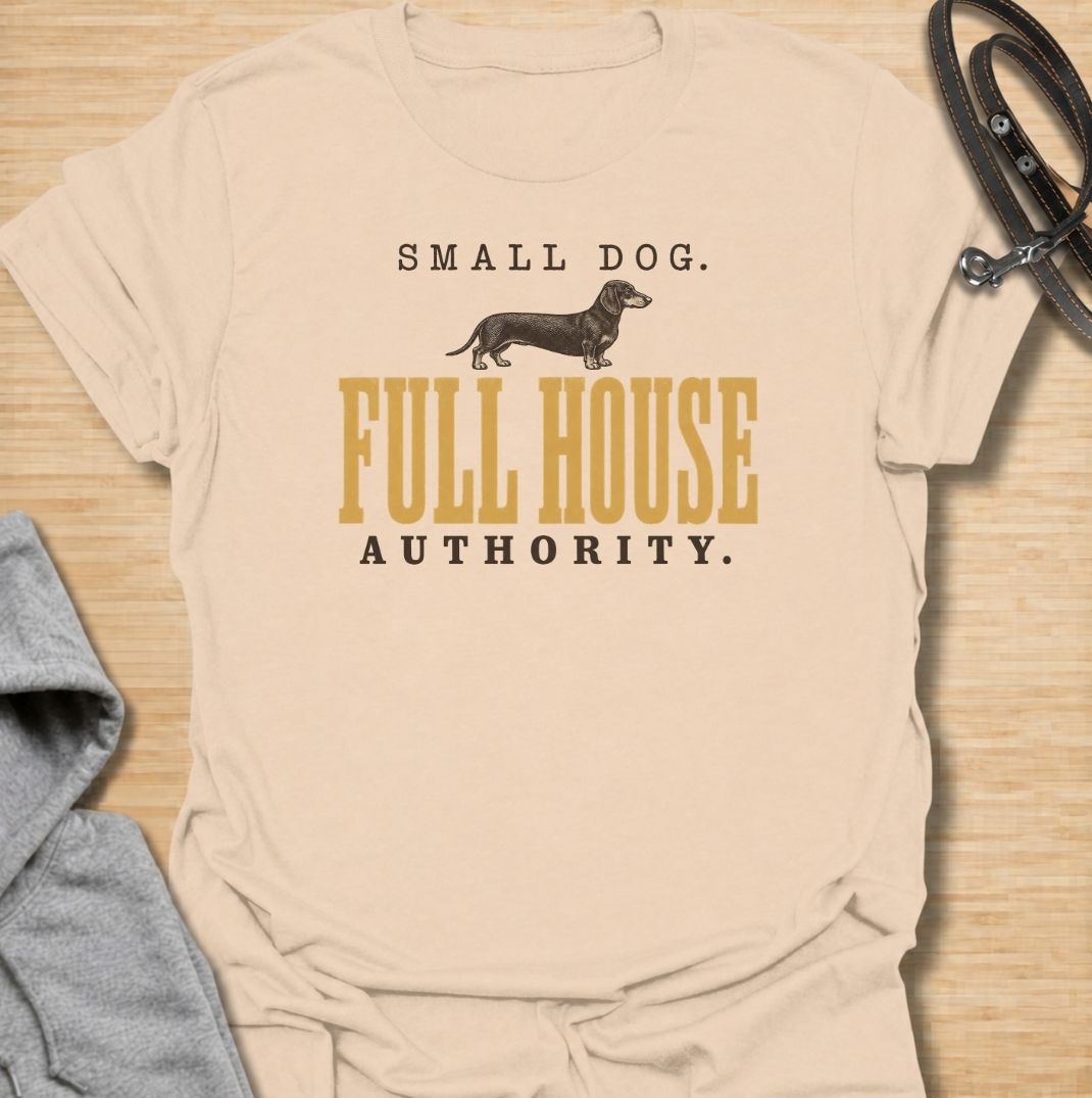 A funny dachshund T-shirt for anyone who knows a small dog can somehow run the entire household. Featuring the phrase “Small Dog. Full House Authority.” with a simple dachshund illustration, this design captures the breed’s confident, bossy personality in a clean vintage-inspired style. Perfect for dachshund moms, dachshund dads, sausage dog owners, and anyone whose little dog acts like the head of the house. A playful everyday tee for fans of dachshund humor, wiener dogs, and small dogs with very big opini