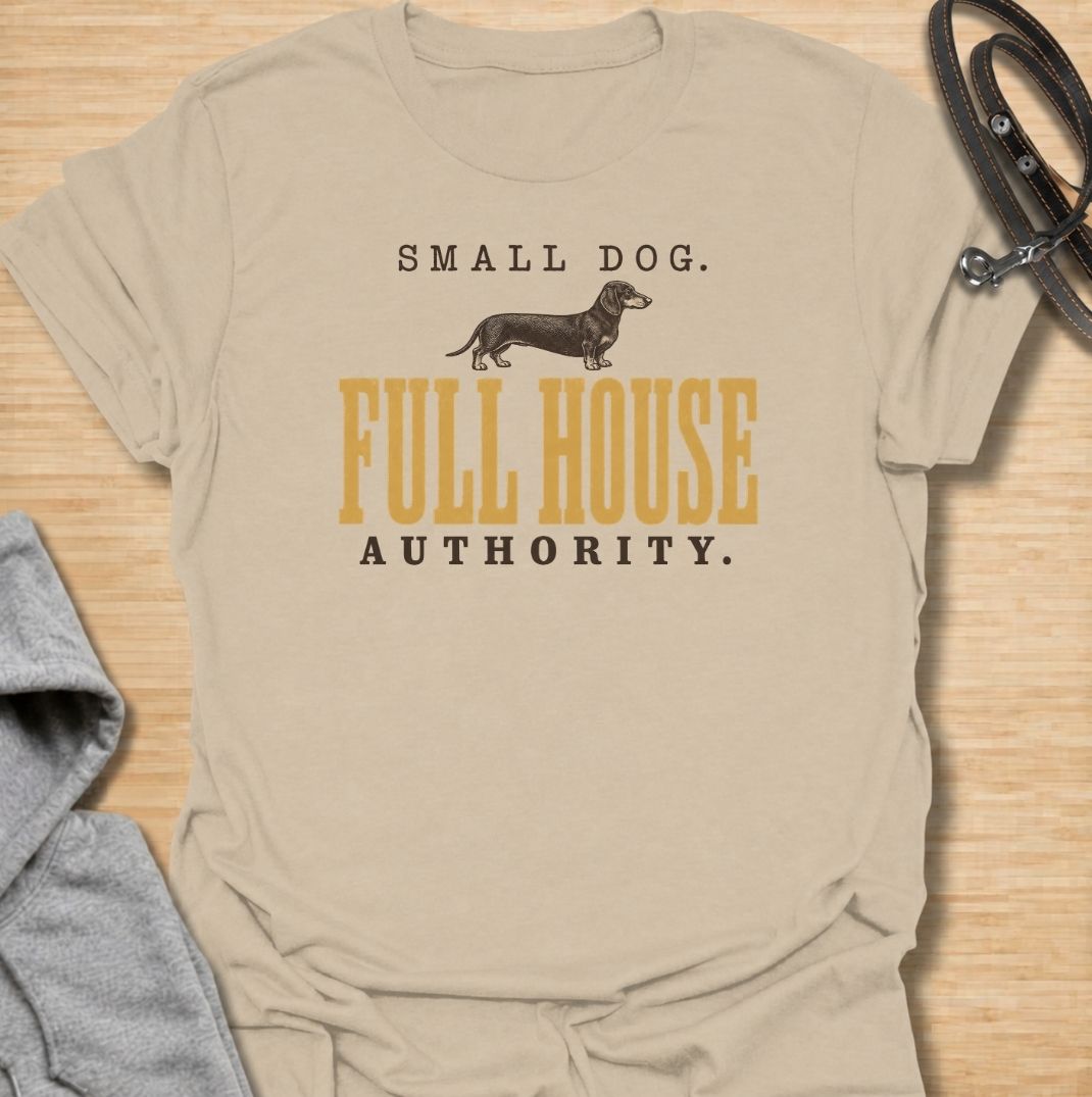 A funny dachshund T-shirt for anyone who knows a small dog can somehow run the entire household. Featuring the phrase “Small Dog. Full House Authority.” with a simple dachshund illustration, this design captures the breed’s confident, bossy personality in a clean vintage-inspired style. Perfect for dachshund moms, dachshund dads, sausage dog owners, and anyone whose little dog acts like the head of the house. A playful everyday tee for fans of dachshund humor, wiener dogs, and small dogs with very big opini