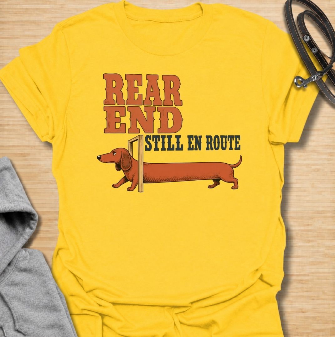 A funny dachshund T-shirt for anyone who knows a sausage dog can seem to arrive in two separate installments. Featuring the phrase “Rear End Still En Route” with a stretched-out dachshund illustration, this design makes the most of the breed’s famously long body. Perfect for dachshund moms, dachshund dads, wiener dog owners, and anyone who loves dry breed-specific humor. A playful everyday tee for fans of dachshunds, sausage dogs, and quirky dog gifts.