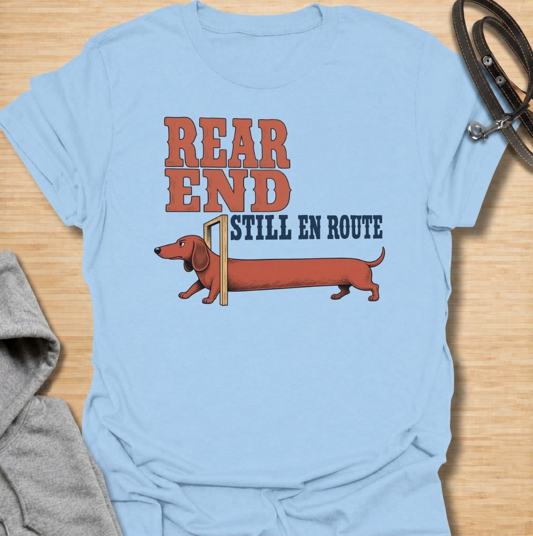 A funny dachshund T-shirt for anyone who knows a sausage dog can seem to arrive in two separate installments. Featuring the phrase “Rear End Still En Route” with a stretched-out dachshund illustration, this design makes the most of the breed’s famously long body. Perfect for dachshund moms, dachshund dads, wiener dog owners, and anyone who loves dry breed-specific humor. A playful everyday tee for fans of dachshunds, sausage dogs, and quirky dog gifts.