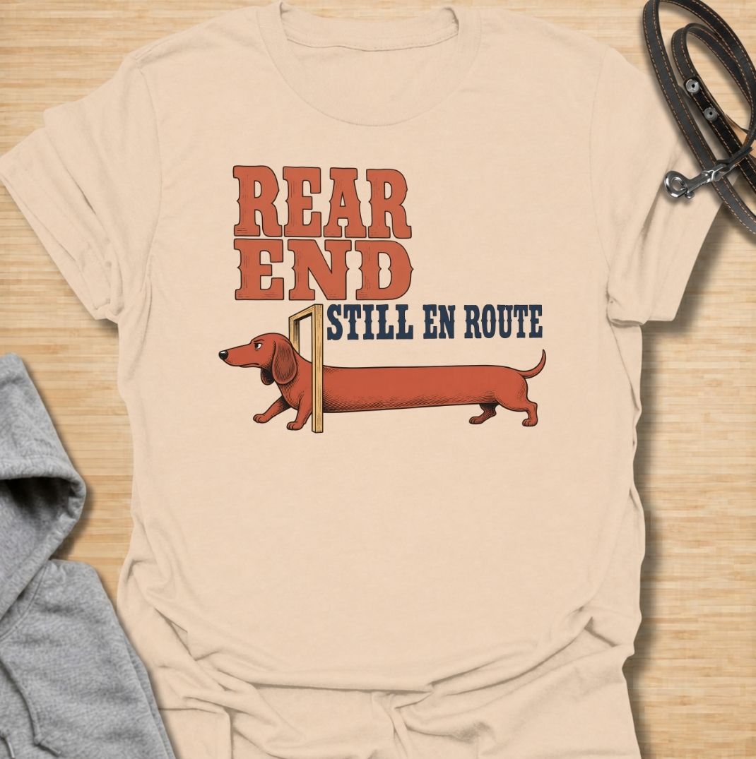 A funny dachshund T-shirt for anyone who knows a sausage dog can seem to arrive in two separate installments. Featuring the phrase “Rear End Still En Route” with a stretched-out dachshund illustration, this design makes the most of the breed’s famously long body. Perfect for dachshund moms, dachshund dads, wiener dog owners, and anyone who loves dry breed-specific humor. A playful everyday tee for fans of dachshunds, sausage dogs, and quirky dog gifts.