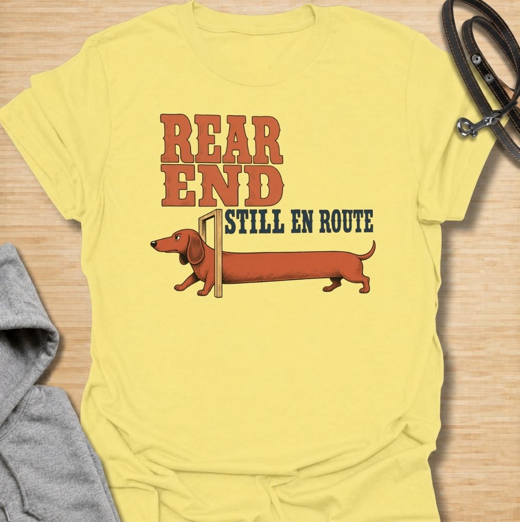A funny dachshund T-shirt for anyone who knows a sausage dog can seem to arrive in two separate installments. Featuring the phrase “Rear End Still En Route” with a stretched-out dachshund illustration, this design makes the most of the breed’s famously long body. Perfect for dachshund moms, dachshund dads, wiener dog owners, and anyone who loves dry breed-specific humor. A playful everyday tee for fans of dachshunds, sausage dogs, and quirky dog gifts.