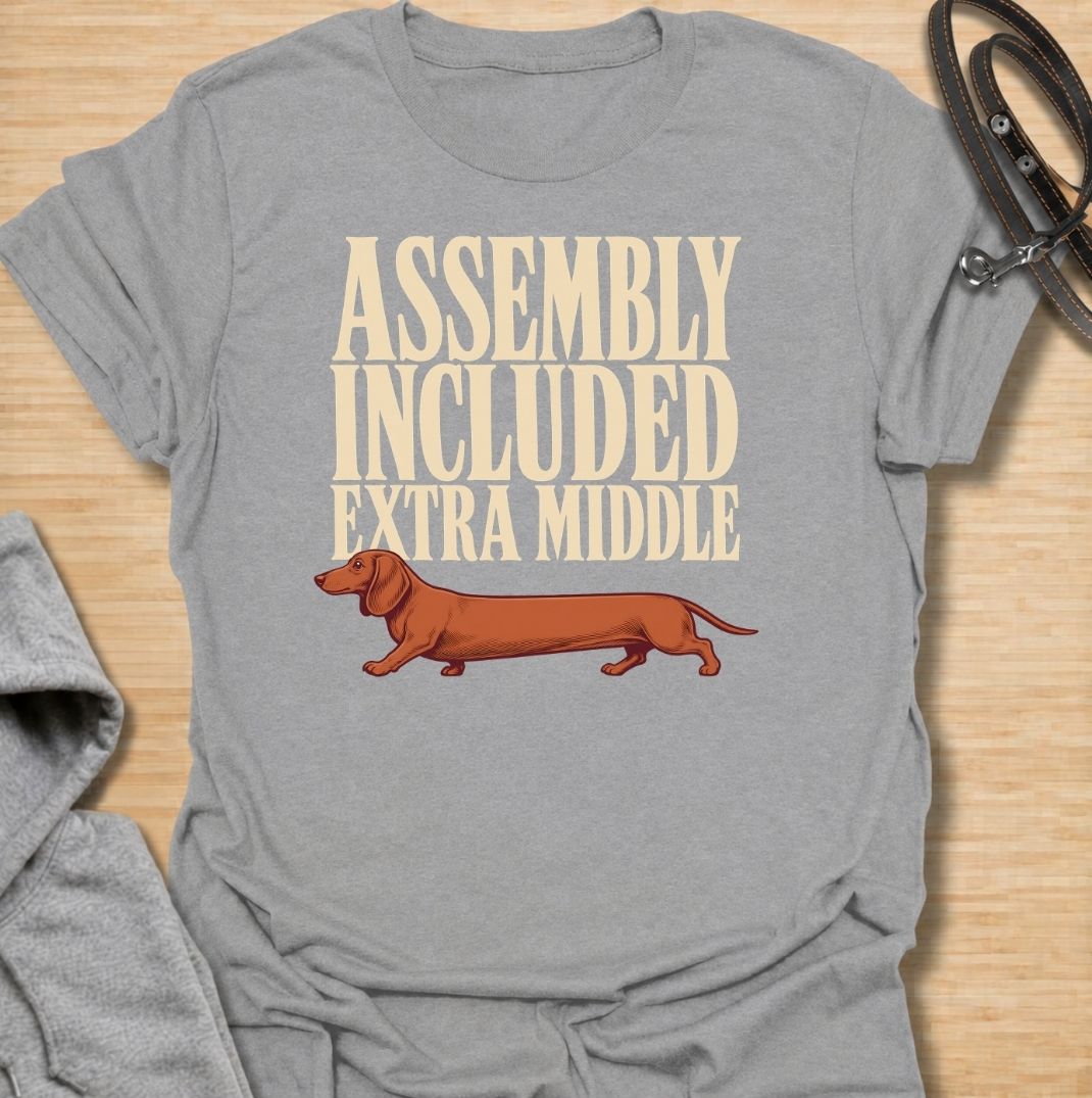 A funny dachshund T-shirt for anyone who knows these little dogs seem to have been built with a little too much middle. Featuring the phrase “Assembly Included Extra Middle” with a long dachshund illustration, this design turns the breed’s unmistakable shape into a dry, clever joke. Perfect for dachshund moms, dachshund dads, sausage dog owners, and anyone who loves breed-specific humor. A playful everyday tee for fans of dachshunds, wiener dogs, and funny dog gifts with a vintage feel.