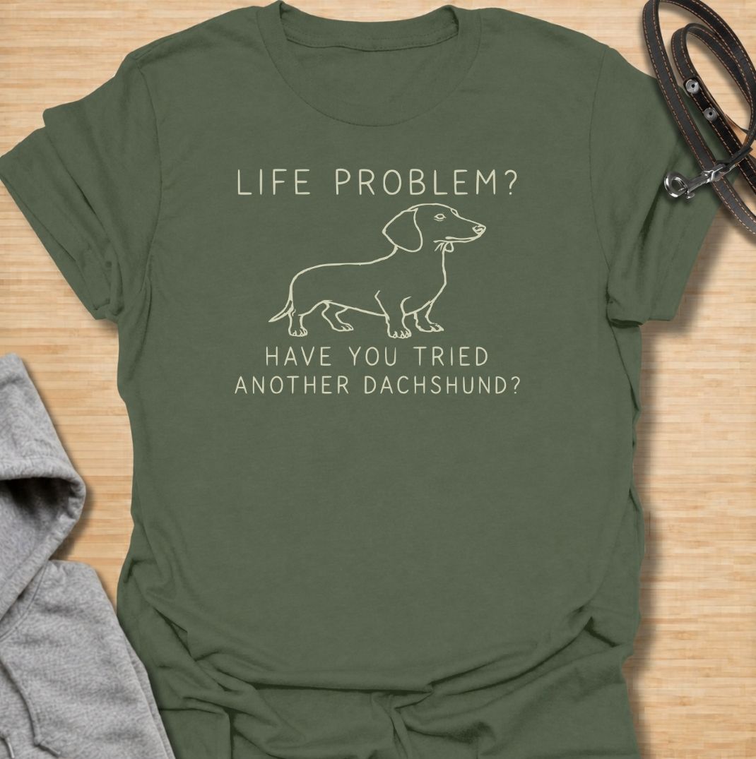A funny dachshund T-shirt for anyone who believes most problems could probably be improved by adding another sausage dog. Featuring the phrase “Life Problem? Have You Tried Another Dachshund?” with a simple line-art dachshund, this design delivers dry breed-specific humor in a clean, easy-to-wear style. Perfect for dachshund moms, dachshund dads, multi-dog households, and anyone always tempted to bring home one more doxie. A playful everyday tee for fans of dachshund humor, wiener dogs, and funny dog