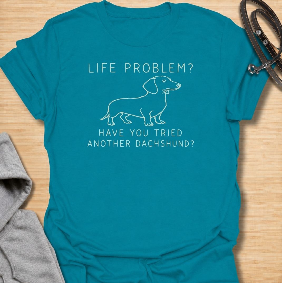 A funny dachshund T-shirt for anyone who believes most problems could probably be improved by adding another sausage dog. Featuring the phrase “Life Problem? Have You Tried Another Dachshund?” with a simple line-art dachshund, this design delivers dry breed-specific humor in a clean, easy-to-wear style. Perfect for dachshund moms, dachshund dads, multi-dog households, and anyone always tempted to bring home one more doxie. A playful everyday tee for fans of dachshund humor, wiener dogs, and funny dog