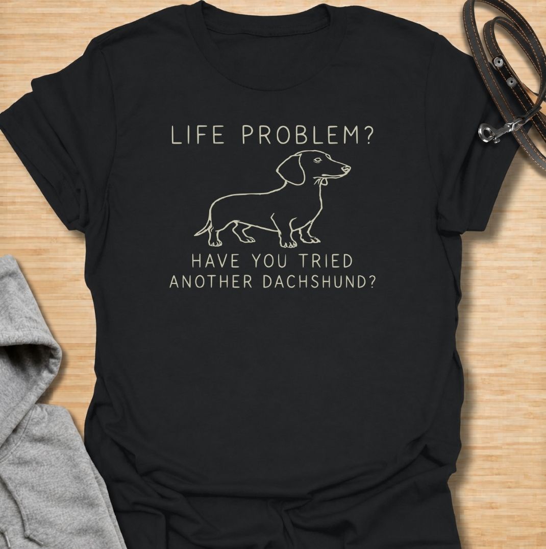 A funny dachshund T-shirt for anyone who believes most problems could probably be improved by adding another sausage dog. Featuring the phrase “Life Problem? Have You Tried Another Dachshund?” with a simple line-art dachshund, this design delivers dry breed-specific humor in a clean, easy-to-wear style. Perfect for dachshund moms, dachshund dads, multi-dog households, and anyone always tempted to bring home one more doxie. A playful everyday tee for fans of dachshund humor, wiener dogs, and funny dog
