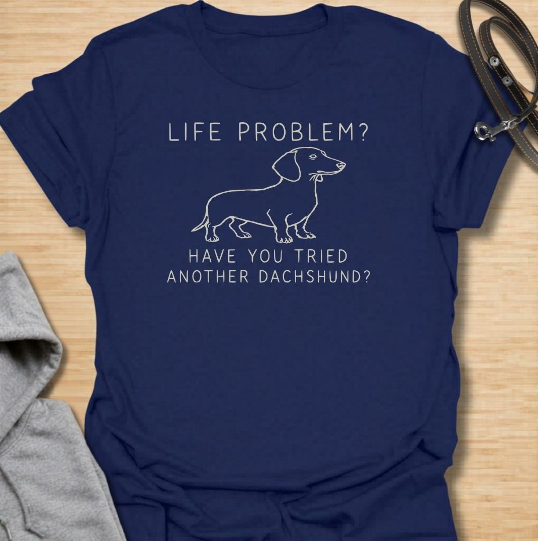 A funny dachshund T-shirt for anyone who believes most problems could probably be improved by adding another sausage dog. Featuring the phrase “Life Problem? Have You Tried Another Dachshund?” with a simple line-art dachshund, this design delivers dry breed-specific humor in a clean, easy-to-wear style. Perfect for dachshund moms, dachshund dads, multi-dog households, and anyone always tempted to bring home one more doxie. A playful everyday tee for fans of dachshund humor, wiener dogs, and funny dog