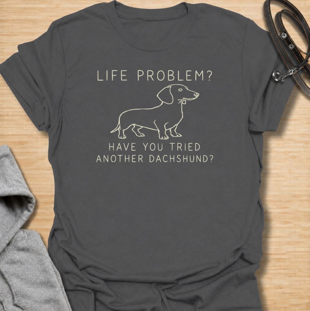 A funny dachshund T-shirt for anyone who believes most problems could probably be improved by adding another sausage dog. Featuring the phrase “Life Problem? Have You Tried Another Dachshund?” with a simple line-art dachshund, this design delivers dry breed-specific humor in a clean, easy-to-wear style. Perfect for dachshund moms, dachshund dads, multi-dog households, and anyone always tempted to bring home one more doxie. A playful everyday tee for fans of dachshund humor, wiener dogs, and funny dog