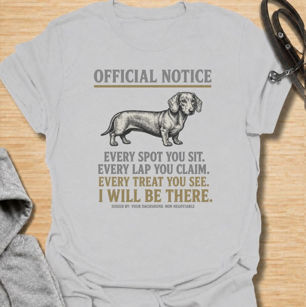 A funny dachshund T-shirt for anyone who knows personal space stops existing once a dachshund moves in. Featuring the phrase “Every Spot You Sit. Every Lap You Claim. Every Treat You See. I Will Be There,” this design captures the breed’s clingy, food-focused personality with dry humor. Perfect for dachshund moms, dachshund dads, sausage dog owners, and anyone living with a devoted little shadow. A playful everyday tee for fans of dachshund humor, velcro dogs, and breed-specific dog gifts.